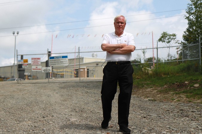 Sen. Tony Avella walks in front of the Williams Compressor Station near Montrose, Pa., Aug. 28, 2013. The Williams Compressor Station, which helps transport gas from wells in the area, caught fire on May 15, 2013. (Kristen Meriwether/Epoch Times)