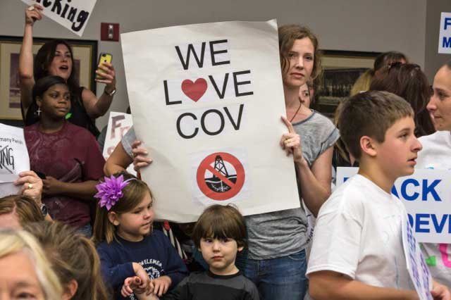 Susan Tarasova with her children at a St. Tammany council meeting.