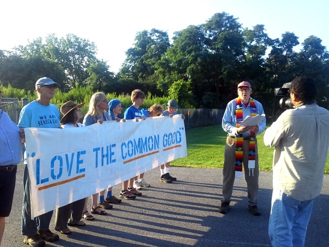 Joining the pontifical read-aloud was the Reverend John D. Elder, former pastor of the historic First Church in Oberlin, Ohio and present part-time resident of Schuyler County. Rev. Elder was not arrested. Photo credit: We Are Seneca Lake 